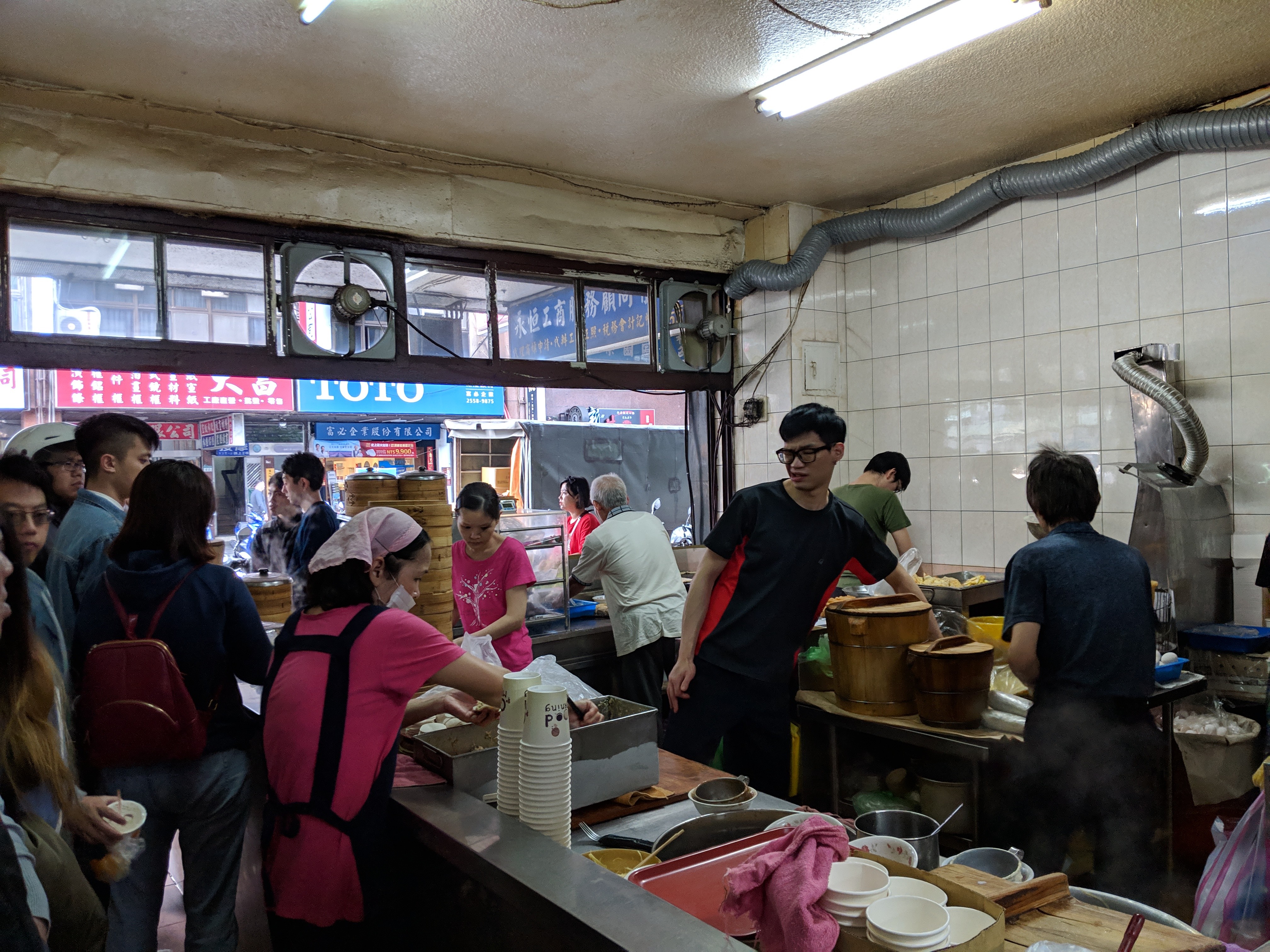 Our view from the line at the youtiao shop, with the cooks hard at work